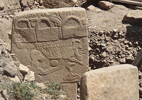 Pillar 43, the 'Vulture Stone,' at Gobekli Tepe, carved with dense reliefs of animals and a headless human figure