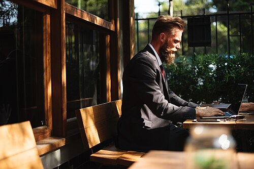 A digital nomad working remotely on a laptop